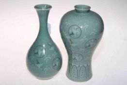 Two Oriental green glazed vases decorated with storks, character mark to bases, 23cm.