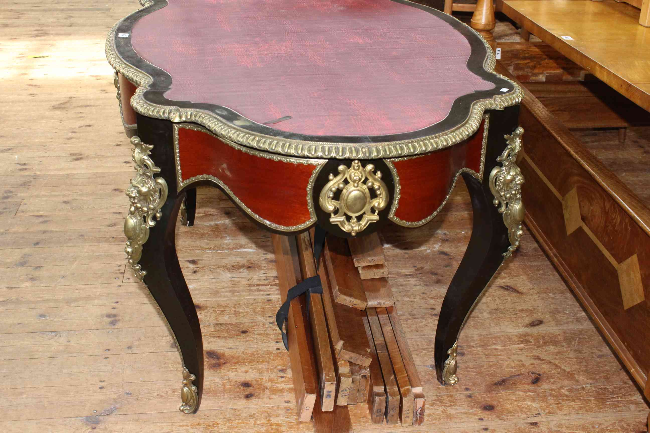 French ebonised and gilt metal mounted bureau plat, of oval shape with inset red leather, - Image 2 of 4