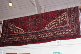 Hand knotted Persian carpet having red ground and central medallion 2.89 by 2.09.