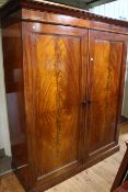 Victorian mahogany two door wardrobe, the right hand fitted with five sliding trays,