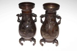 Pair of bronze baluster vases, with relief decoration and on elephant mask legs, 27cm.