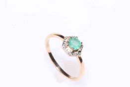 Two 9 carat gold and emerald rings, one with round emerald with fancy border and six diamonds,