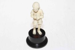Ivory figure of small boy with fish catch, on base, 13cm.