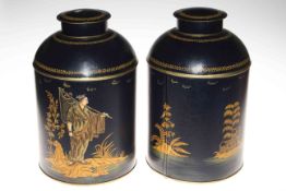 Pair of large tin storage containers decorated with Oriental fisherman, 36cm high.