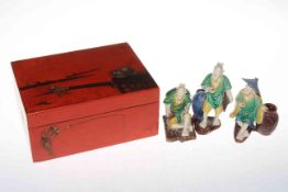 Chinese red lacquered box with mah-jong pieces, and three pottery figures (4).