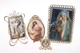 Collection of four decorated brass easel photograph frames, largest 18.5cm by 12.5cm.