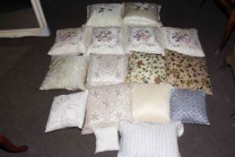 Fifteen scatter cushions including beaded and embroidered, and two canework light fittings.