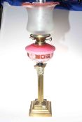 Victorian brass square reeded column oil lamp with an etched shade and a pink reservoir, 78cm high.