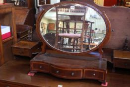 Edwardian mahogany and line inlaid oval toilet mirror on three drawer serpentine front base.