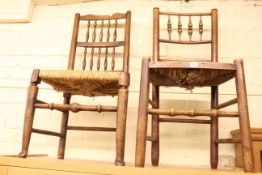 Two 19th Century country oak rush seated side chairs.
