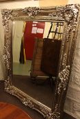 Large ornate framed bevelled wall mirror, 153cm by 124cm overall.