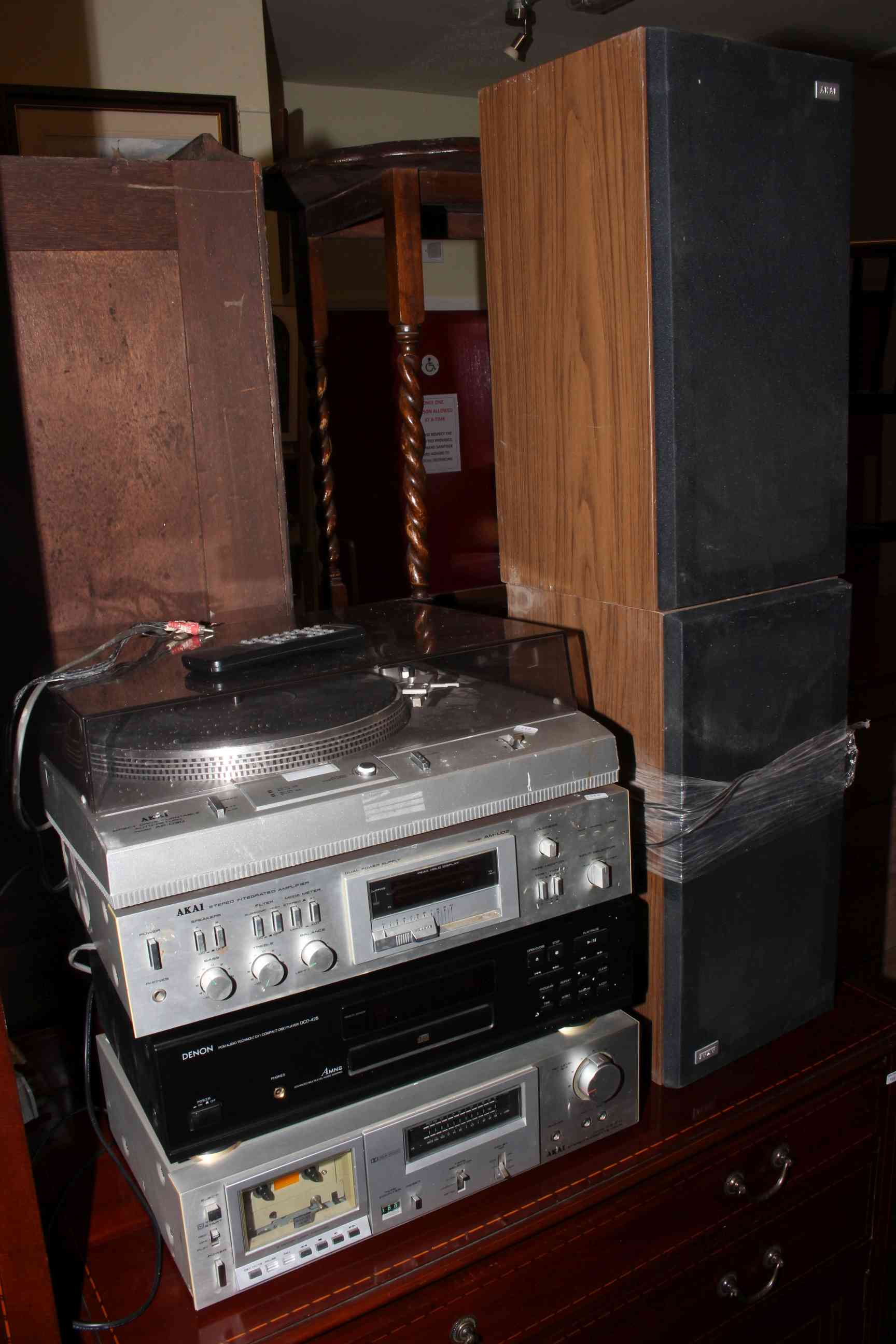 Akai turntable, amplifier, tape deck and two speakers together with Denon compact disc player.
