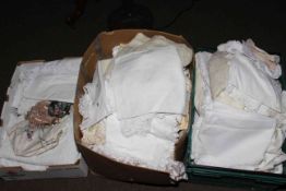 Two boxes of linens and fabrics.