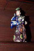 Japanese figure in colourful costume, 28cm high.