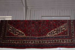 Hand knotted Persian carpet having red ground and central medallion 2.89 by 2.09.