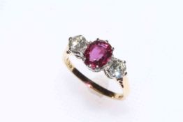 18 carat gold three stone ruby and diamond ring, the ruby approximately 0.