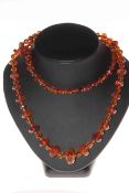 Brown amber necklace of mixed size faceted beads, 88cm length.