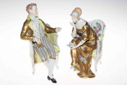 Pair Dresden porcelain figures of seated lady and gentleman, 23cm, blue mark.