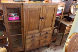 1920's/30's oak breakfront cabinet having two central cupboard doors above five drawers flanked by