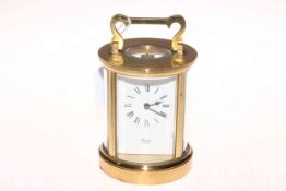 Gilt brass cased circular carriage clock, the face signed Huber, London, 15cm high.