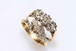 Two 18 carat yellow gold and three stone diamond set rings, sizes M/N.