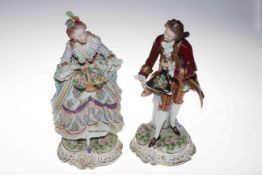 Pair large Sitzendorf porcelain figures of a lady with basket of flowers and gallant in crimson