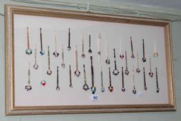 Framed collection of thirty two bodkins of ivory/bone/wood and glass beads, 45cm by 83cm.