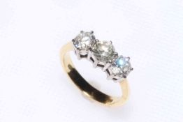 Three stone diamond ring set in 18 carat yellow gold, totalling over 1 carat in diamonds, size J.