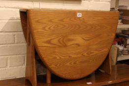 Ercol Windsor drop leaf low centre table, 47cm high by 70cm wide.