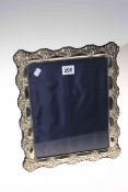 Large embossed silver easel photograph frame, 32cm by 27cm.