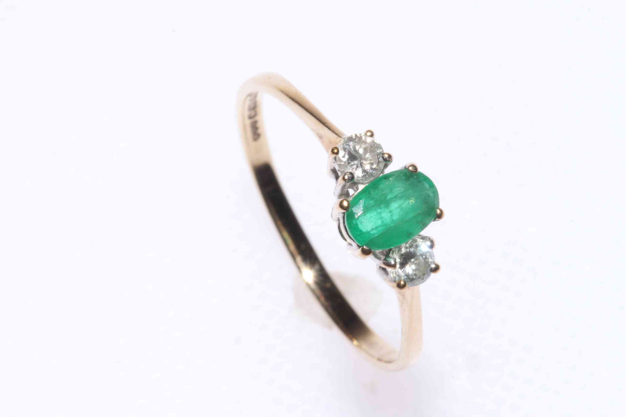 Three stone emerald and diamond ring set in 9 carat gold, size Q.