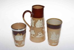 Royal Doulton Lambeth jug and two beakers, one beaker has a silver collar, 20cm and 12cm high.