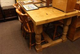 Rectangular pine dining table and four spindle back chairs.