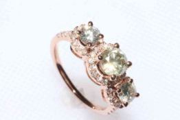 14 carat rose gold and diamond trilogy ring having three elevated brilliant cut diamonds with