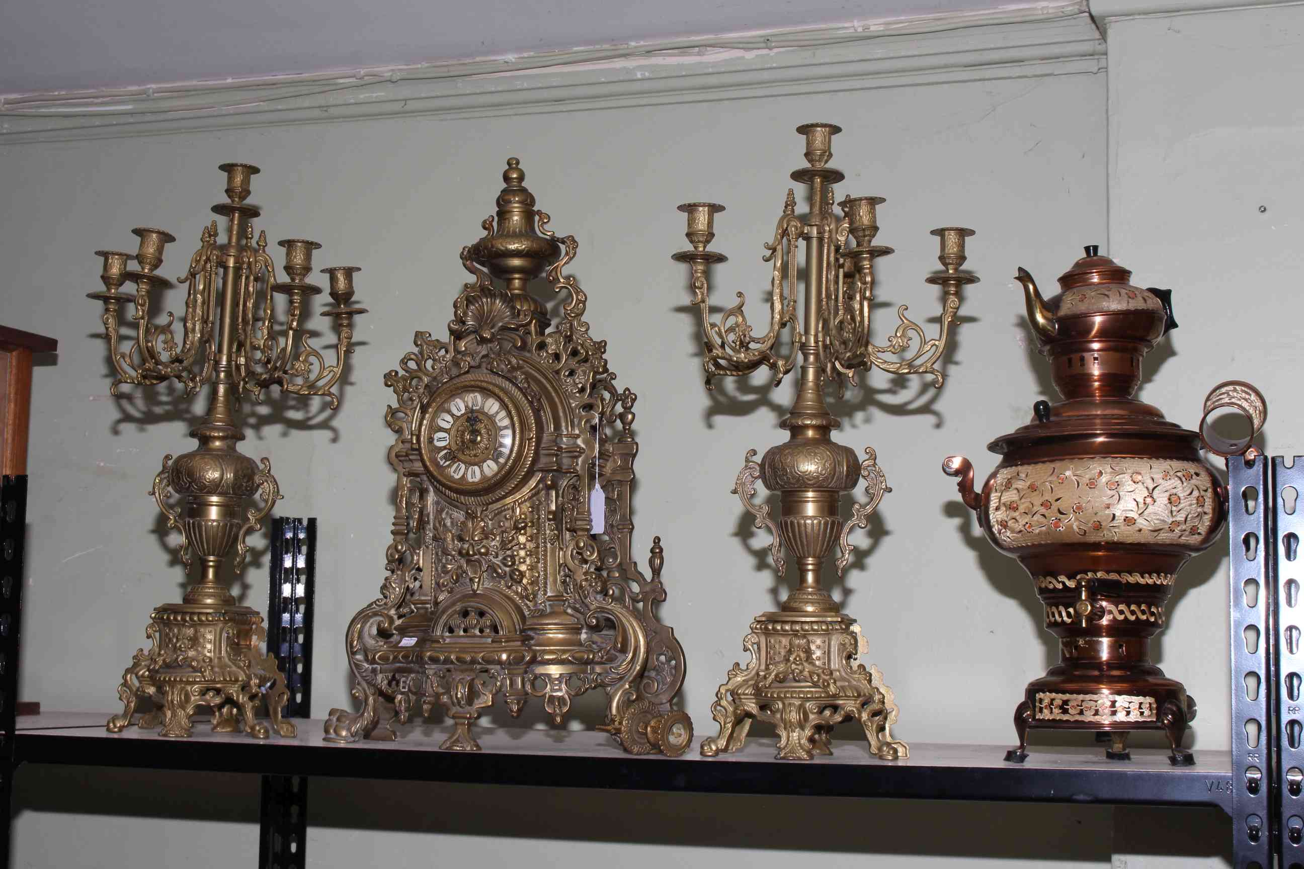Ornate gilt metal three piece clock garniture and a copper samovar.