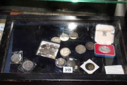 Small display case with silver and other coinage.