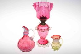 Victorian cranberry glass oil lamp, ewer and small jug.