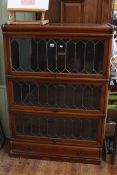 Globe Wernicke mahogany three tier stacking bookcase with leaded glass doors and base drawer,