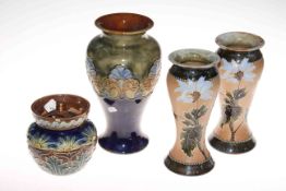 Three Royal Doulton Lambeth vases and a tobacco jar, 23cm, 27cm and 14cm.