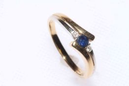 18 carat gold, sapphire and diamond three stone ring, size R.