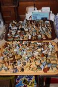 Two trays of Wade Whimsies, approximately 200 pieces together with Wade catalogues and boxes.