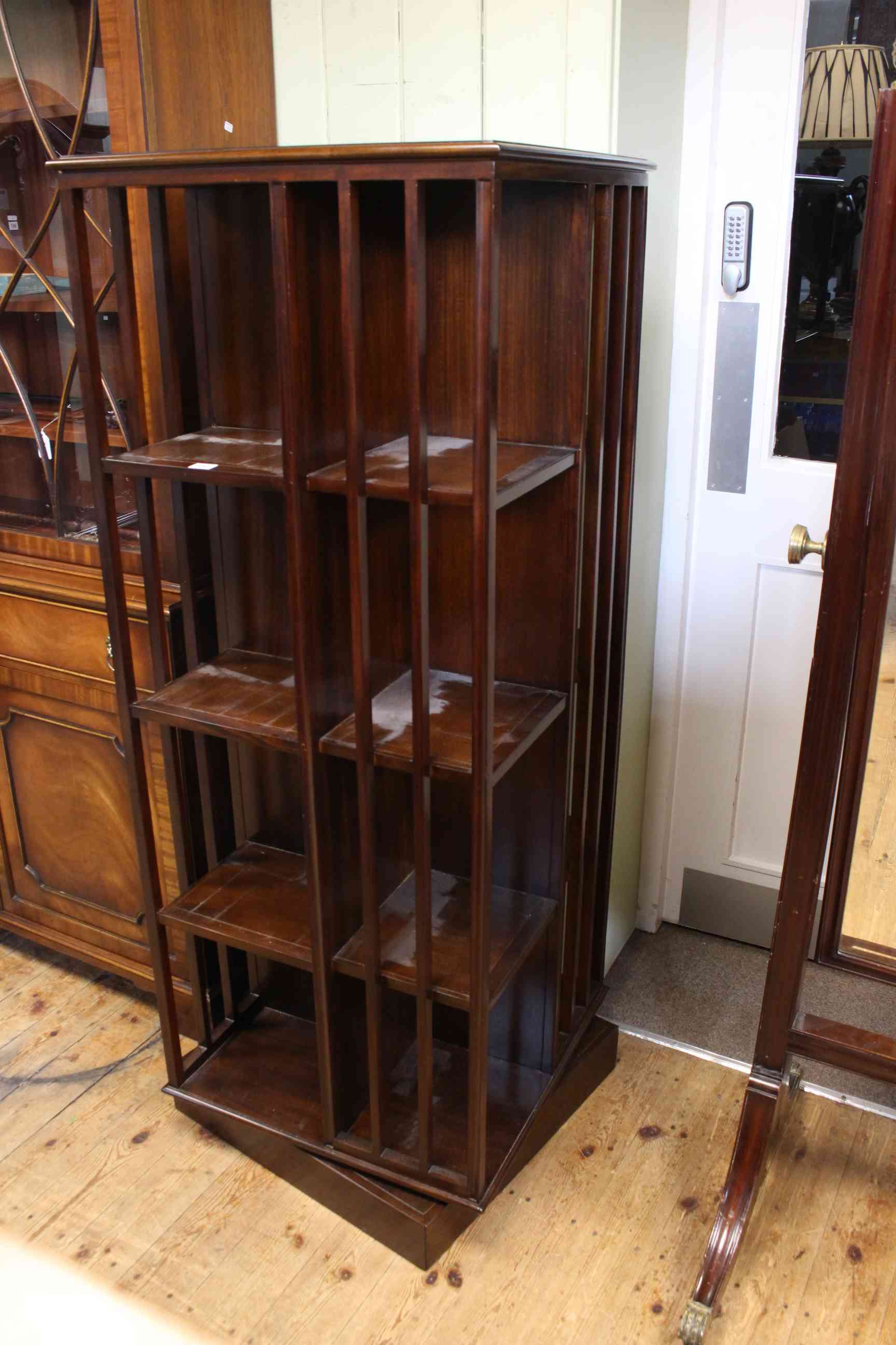 Mahogany four tier revolving bookcase, 157cm high by 60cm wide.