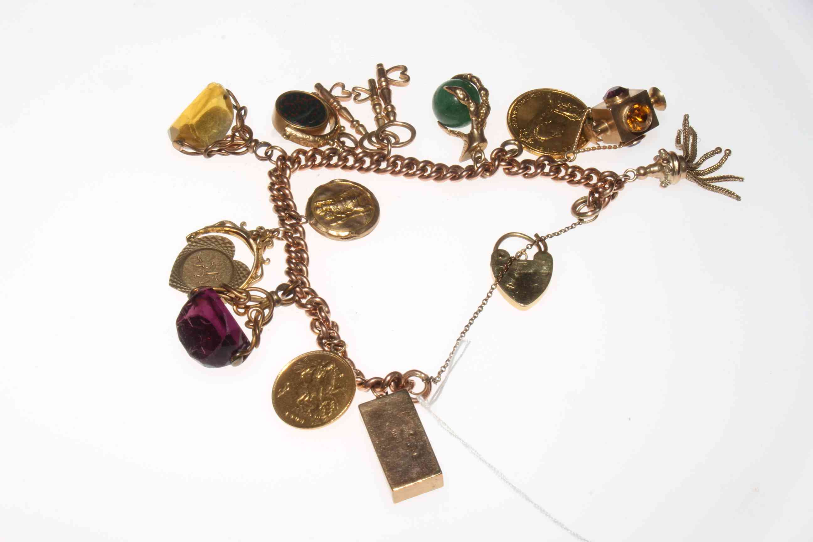 9 carat gold charm bracelet with twelve charms including 1887 sovereign and 1908 half sovereign.