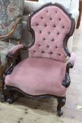 Victorian mahogany framed open armchair in rose pink buttoned fabric.