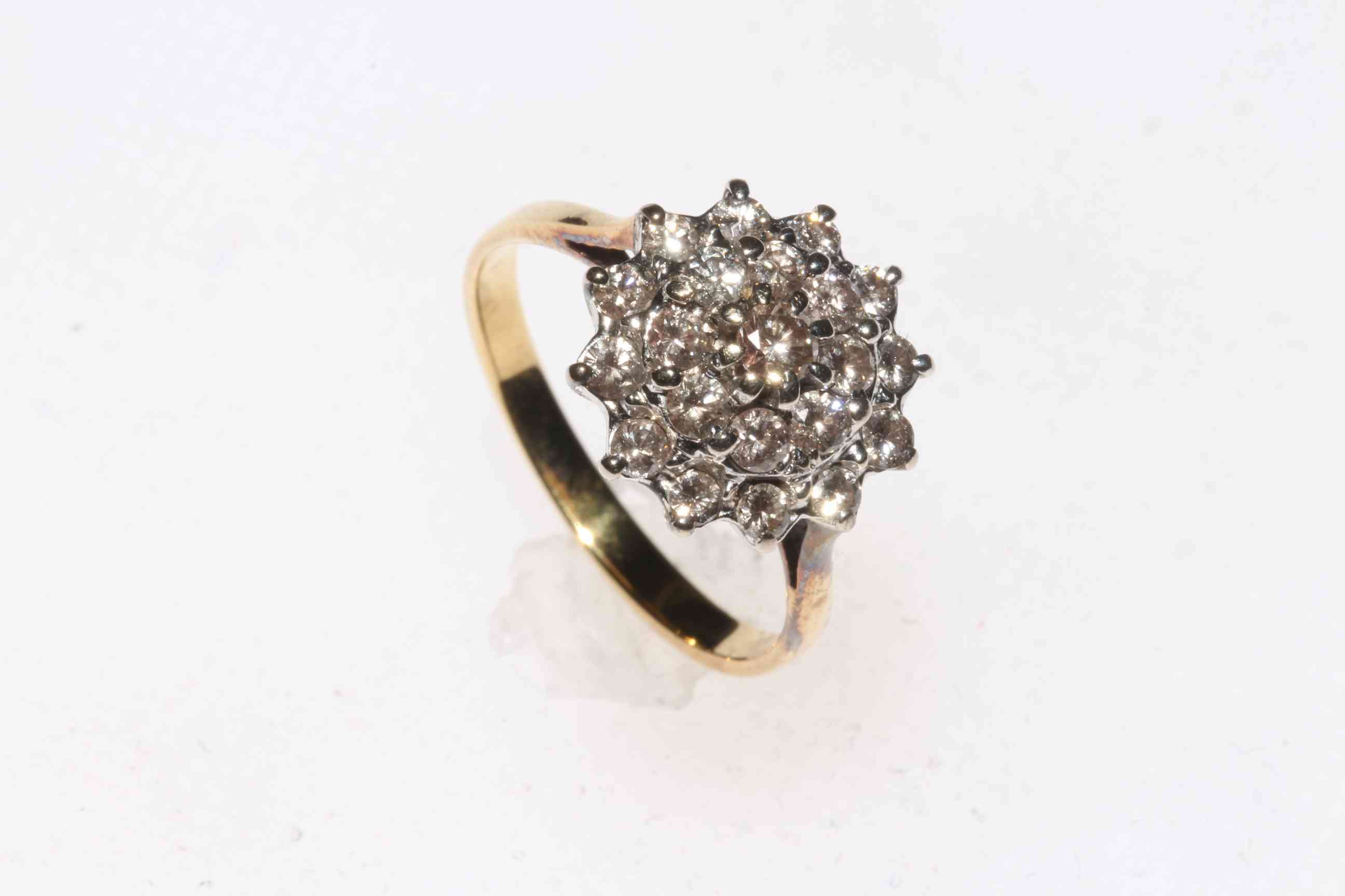 Diamond twenty one stone cluster ring in white setting with yellow gold shank,