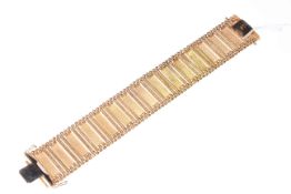 18k gold bracelet with engine-turned panels and bead border, 18cm length.