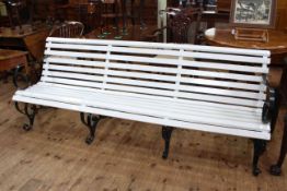 Wrought iron and wood slat scroll arm three seater garden bench, 81cm high by 214cm wide.
