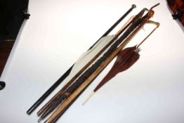 Collection of walking canes including silver collared and tops.