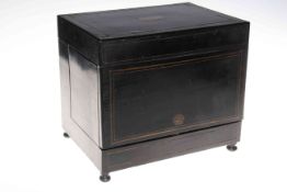 Ebonised and brass inlaid tantalus, the lid enclosing four decanters and twelve glass,