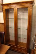 Selva, Italy cherrywood illuminated display cabinet having two glazed doors above a base drawer,